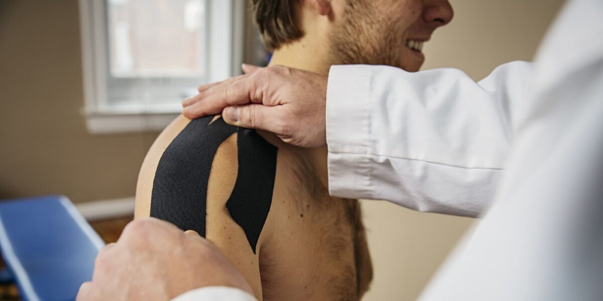 Texas orthopedic sports medicine Doctor applying shoulder tape