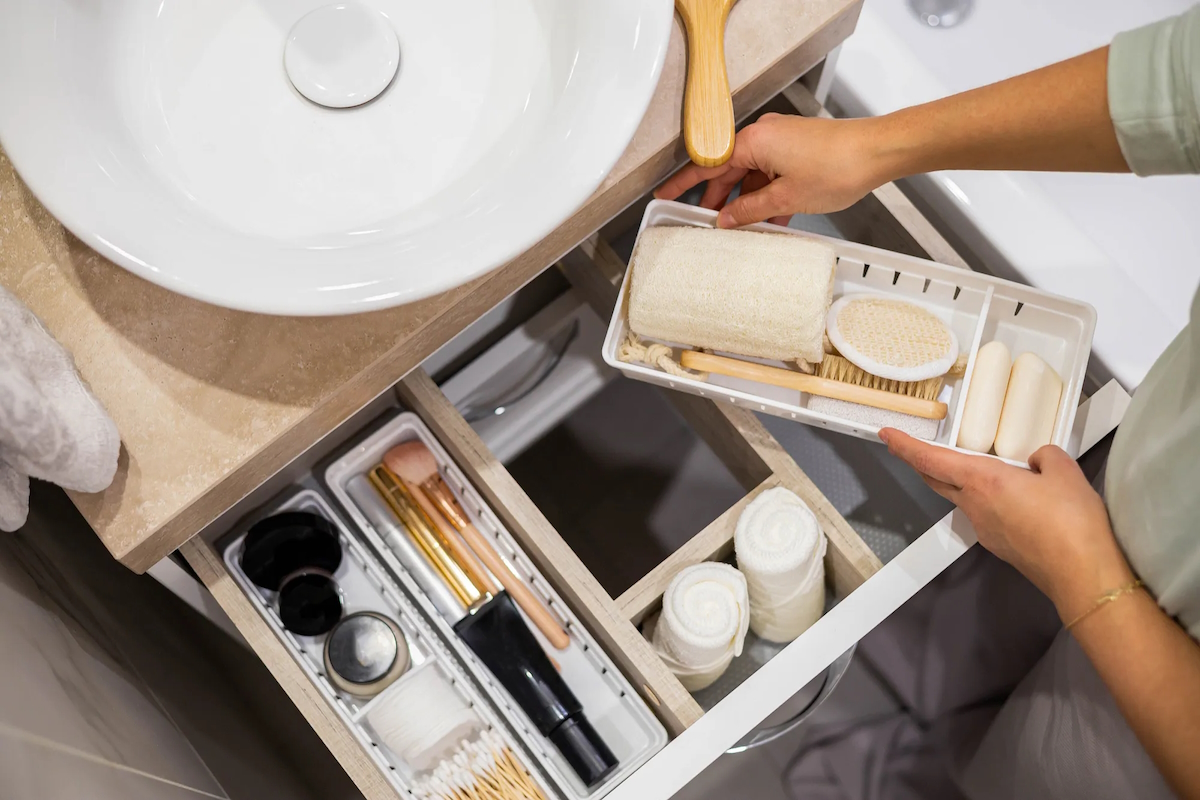 hand surgery recovery woman organizing bathroom toiletries